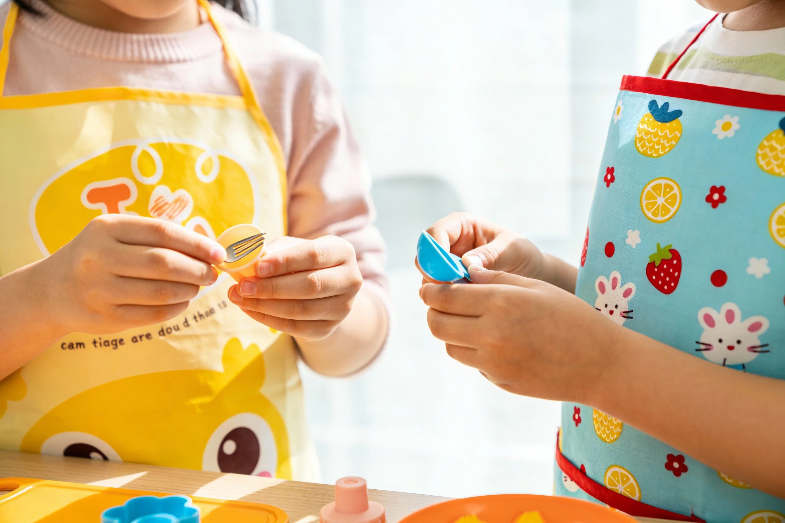 Children wearing cooking aprons