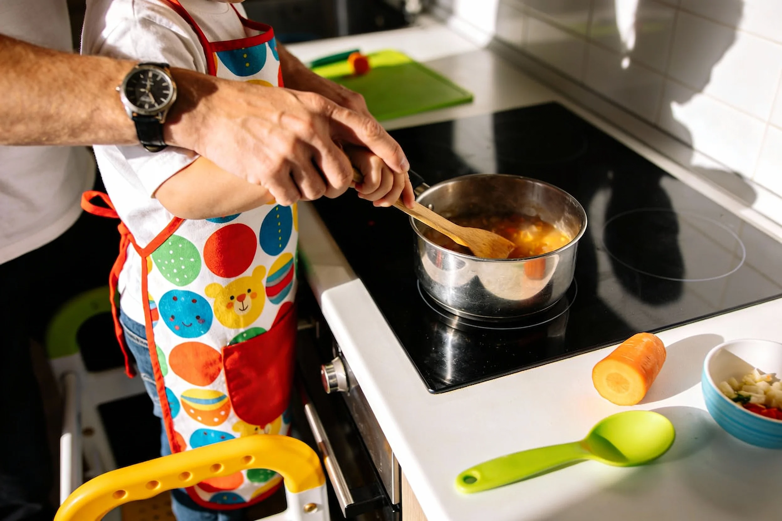 Child cooking with supervision